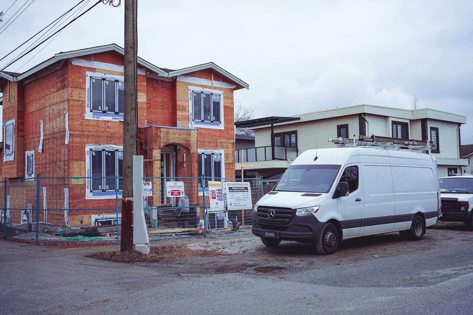 A white sprinter van parked at a job site